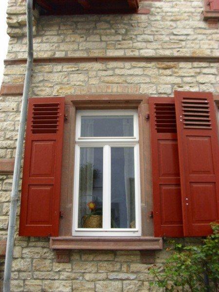 Sanierung der Fenster in weiß mit roten Klappläden 